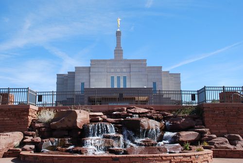 The fountain on the grounds of the Snowflake Arizona Temple, with the fence and a partial view of the temple in the background.