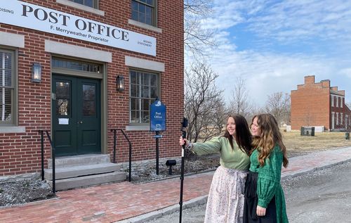 Sister missionaries giving virtual tour in Nauvoo on Main Street