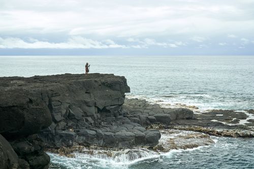 Moroni, son of Mormon, stands on a rocky shore overlooking the ocean.