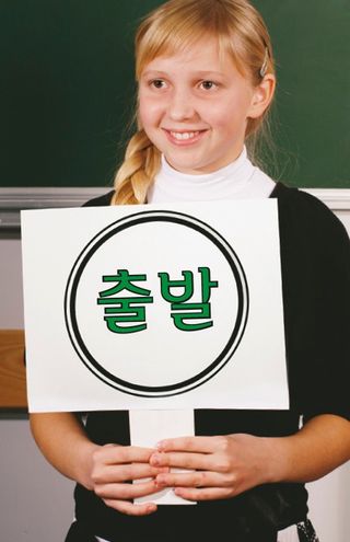 girl standing in front of chalkboard