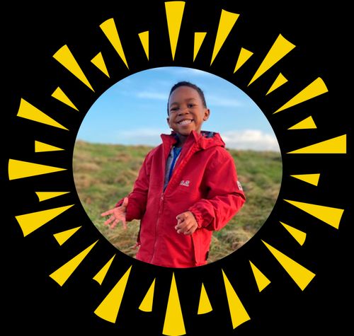 boy outside in red coat