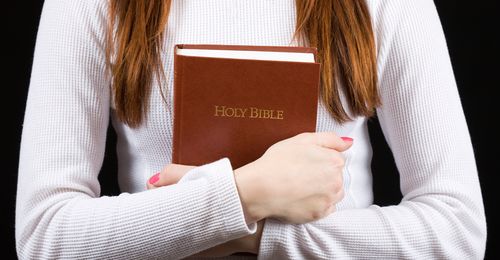 young woman holding Bible