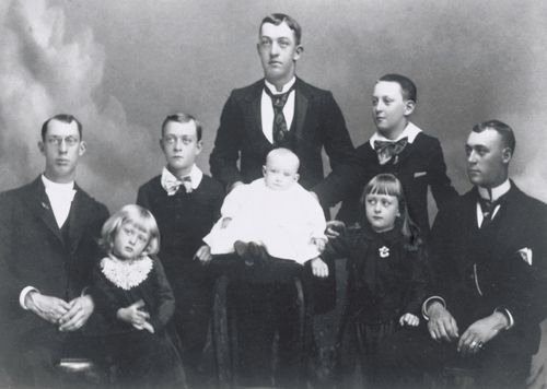 George Albert Smith with his brothers in suits and ties and his sisters in dresses.