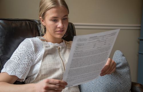 photo of young woman reading patriarchal blessing