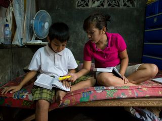 brother and sister studying the scriptures