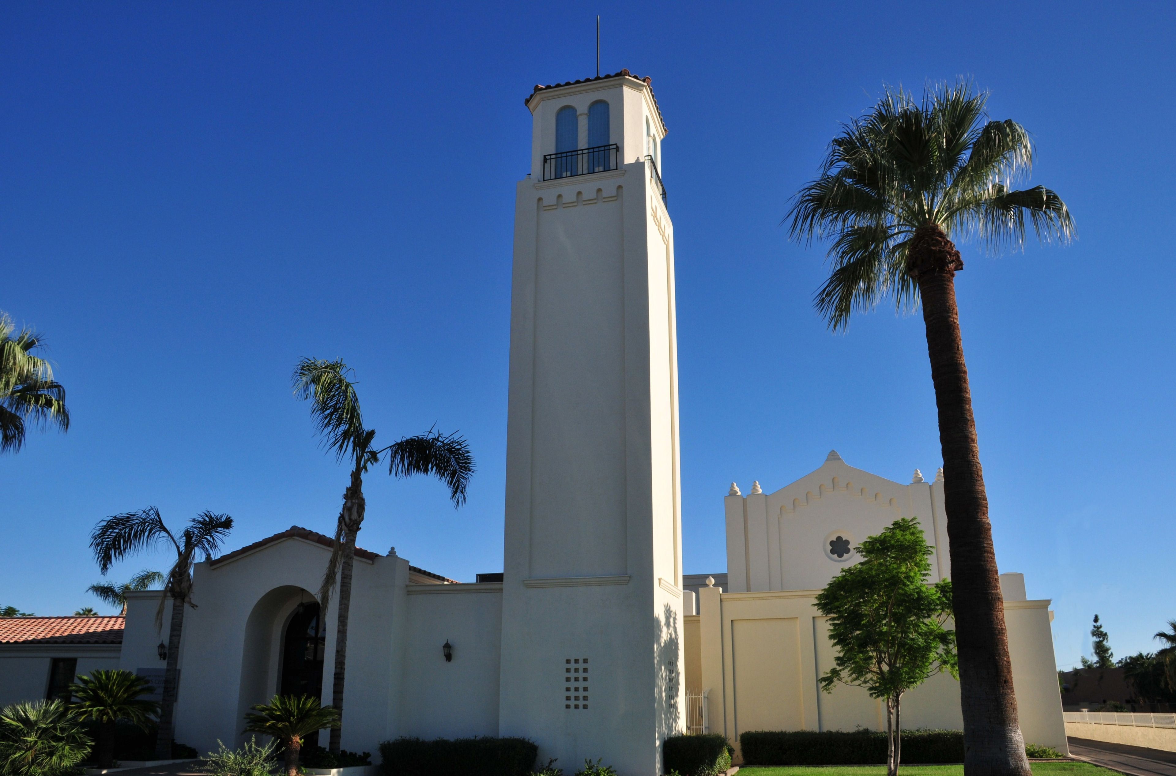 A white chapel and palm trees in Mesa, Arizona.