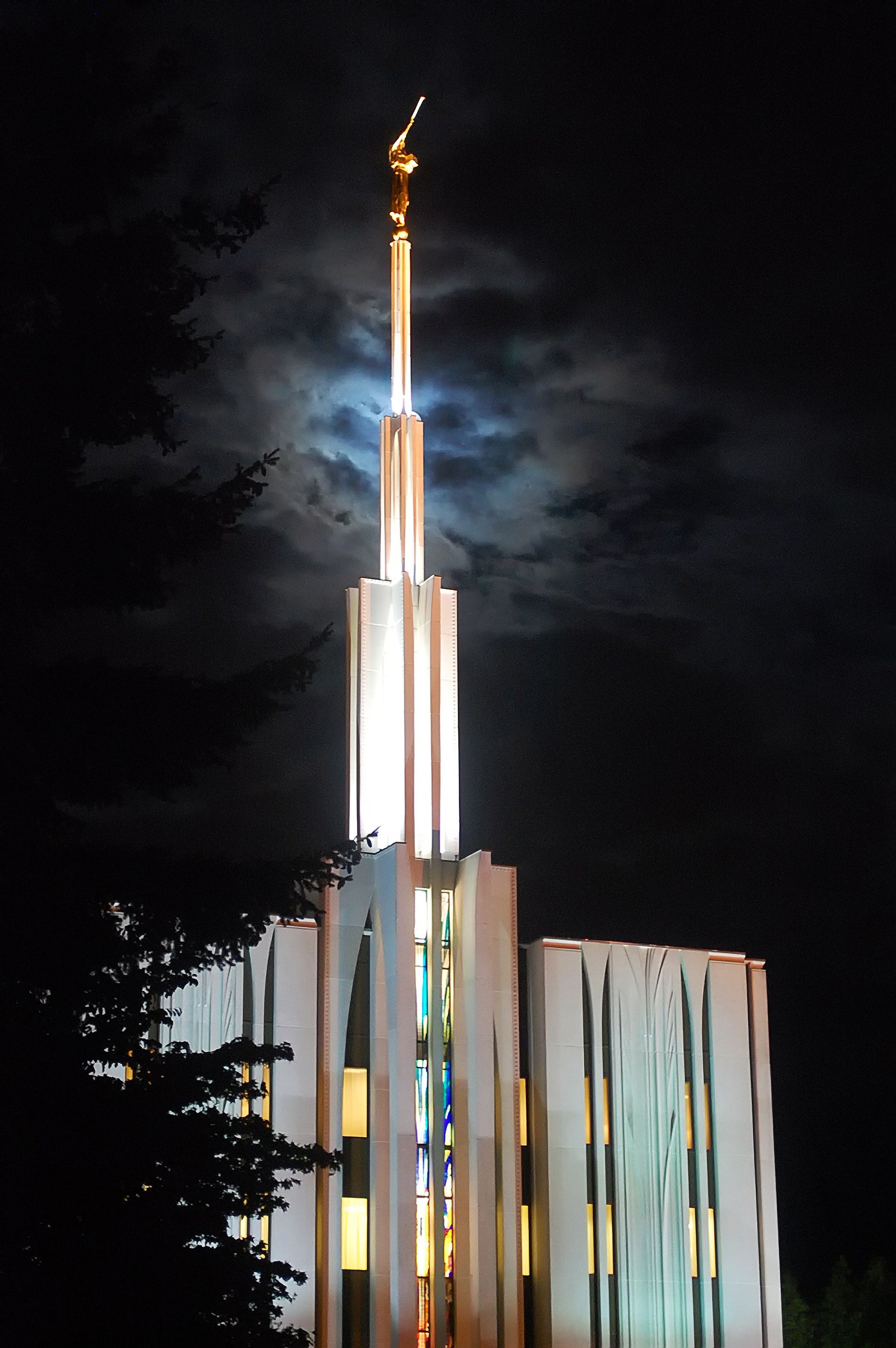 The Seattle Washington Temple in the evening, including the spire, windows, and scenery.