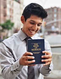 young man with Book of Mormon