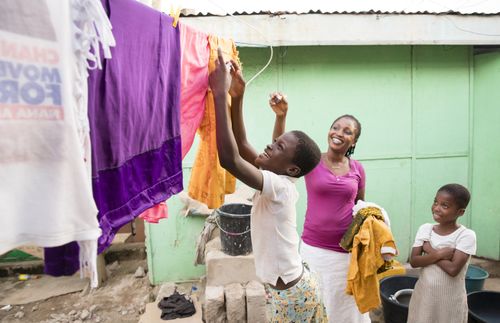 mother and daughter hanging up laundry