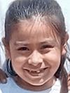 Mariana Sanchez Santos smiles as she stands with her father on her baptism day.