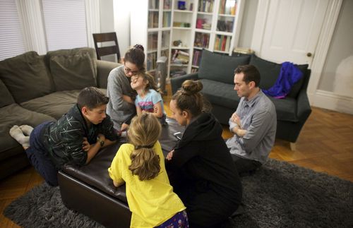 A father and mother spend time with their children.