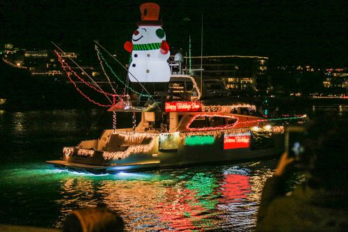 A festive, illuminated boat sails in the Newport Beach Boat Parade in California.