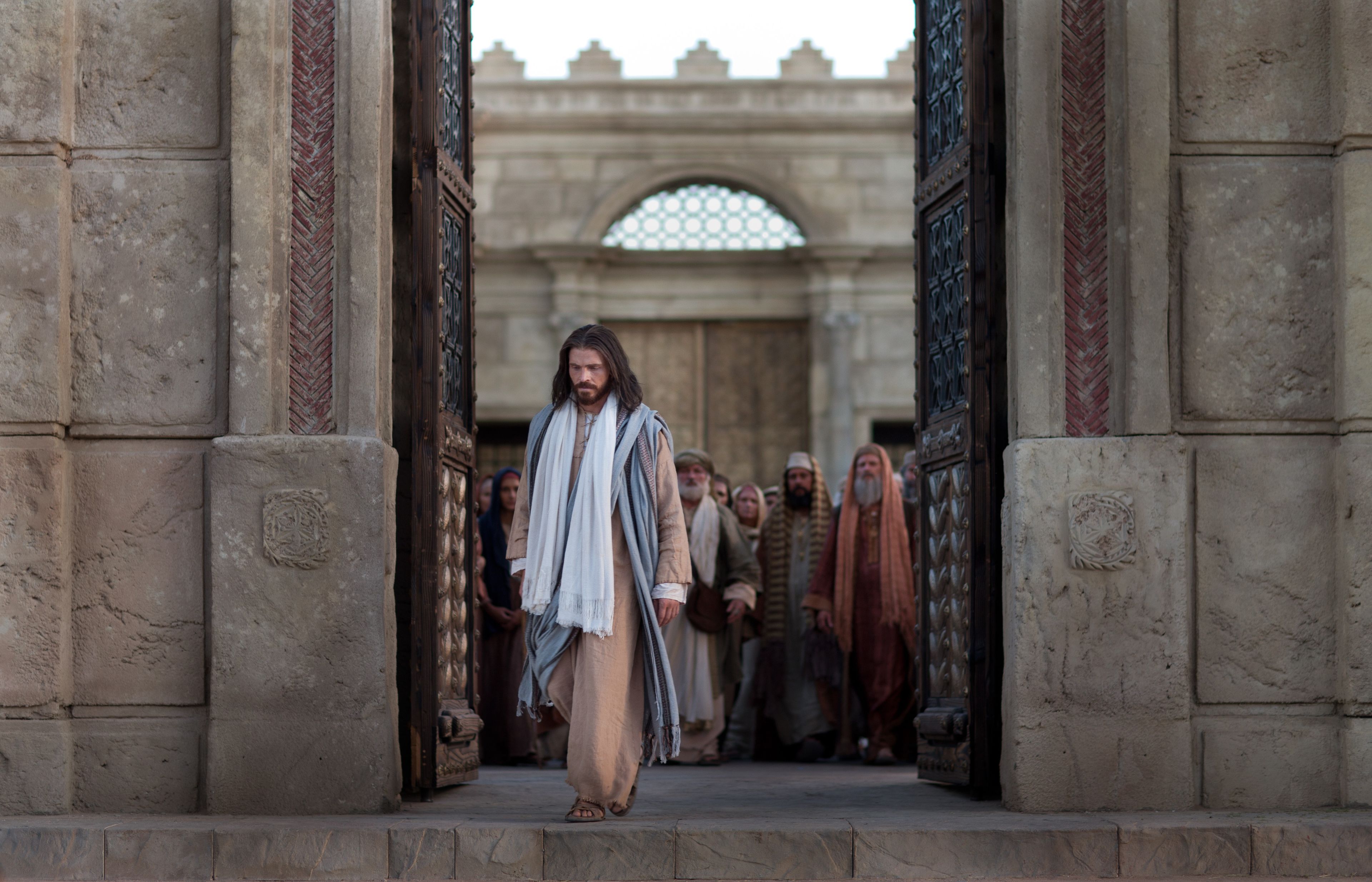 Jesus exits the temple as Pharisees question Him.