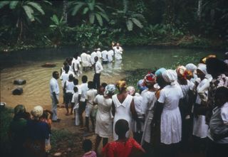 Elder Cannon baptizing converts