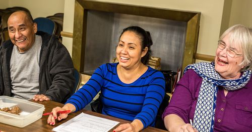 three people in English class smiling