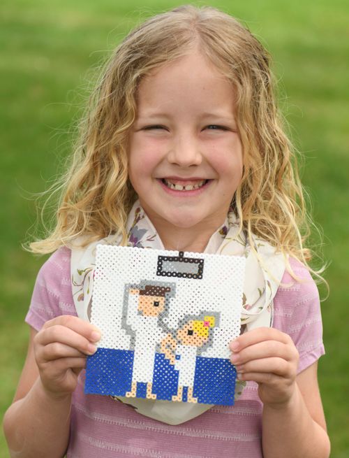 Girl holding beadwork of baptism