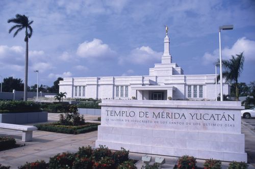 The Mérida Mexico Temple name sign up close, with the temple in the background.