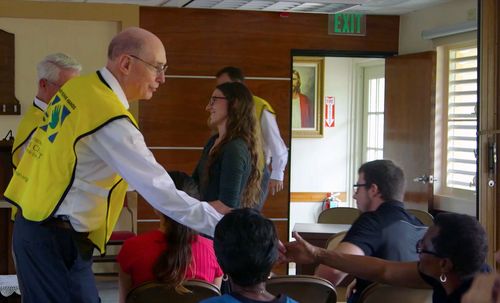 President Henry B. Eyring visiting with volunteers