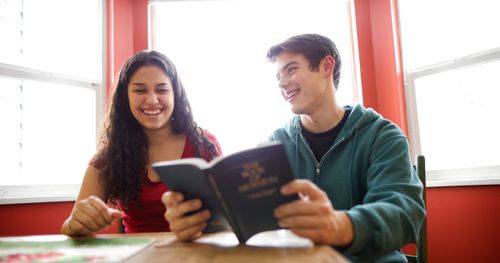 young woman and young man reading the Book of Mormon