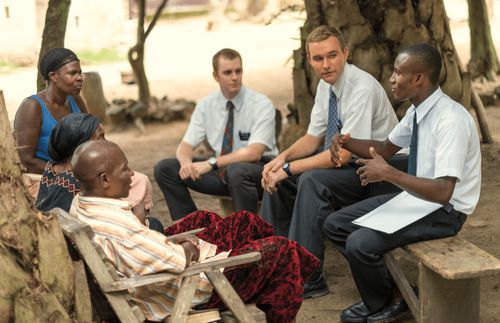 Elder missionaries teaching people in Ghana.