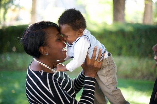 A black woman holding a baby boy.