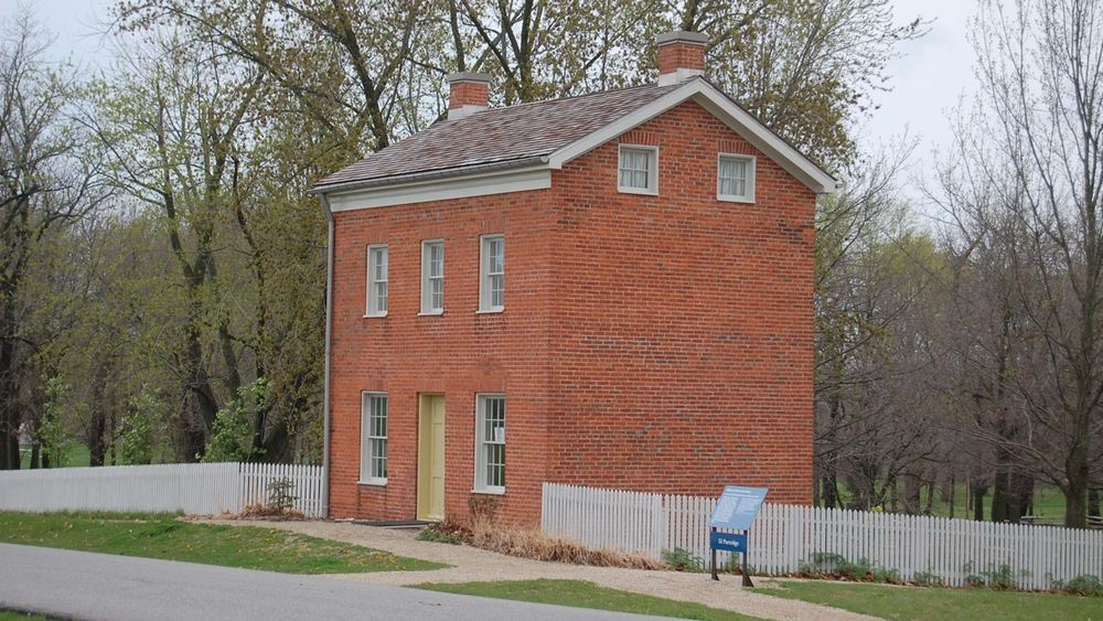 Two-and-a-half-story red brick home.