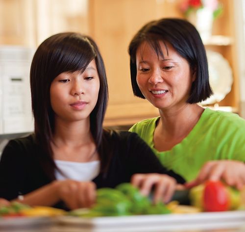 daughter and mother cooking