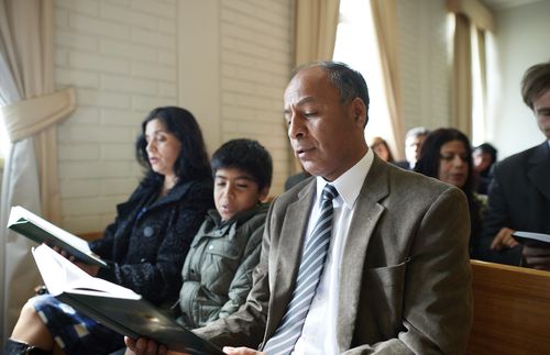 family sitting in sacrament meeting