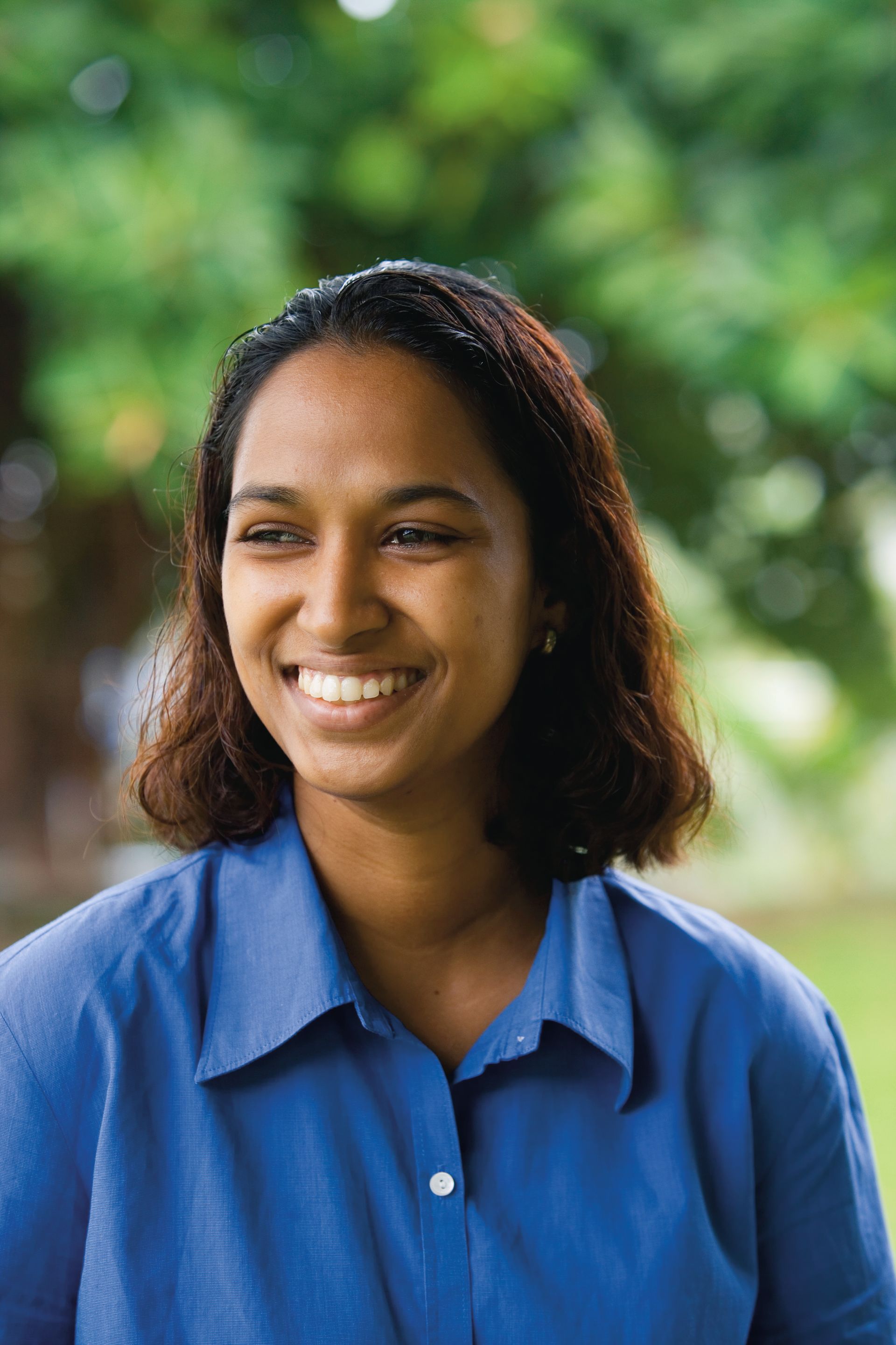 A portrait of a young woman in Fiji smiling.