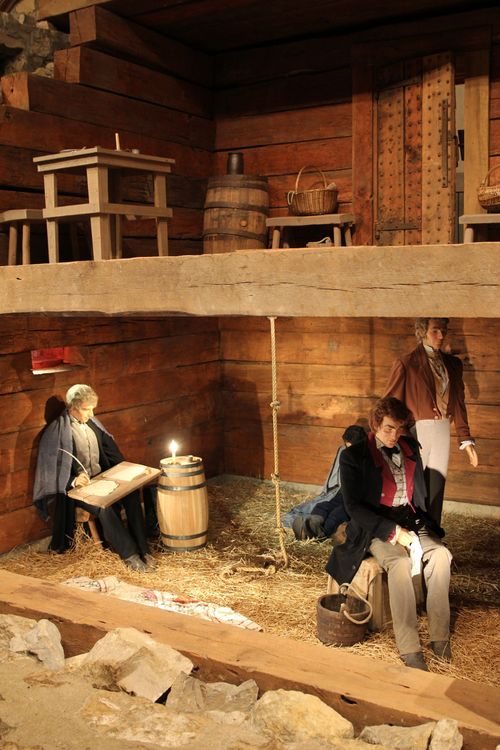 A small replica of Liberty Jail depicting Joseph Smith and two other prisoners.