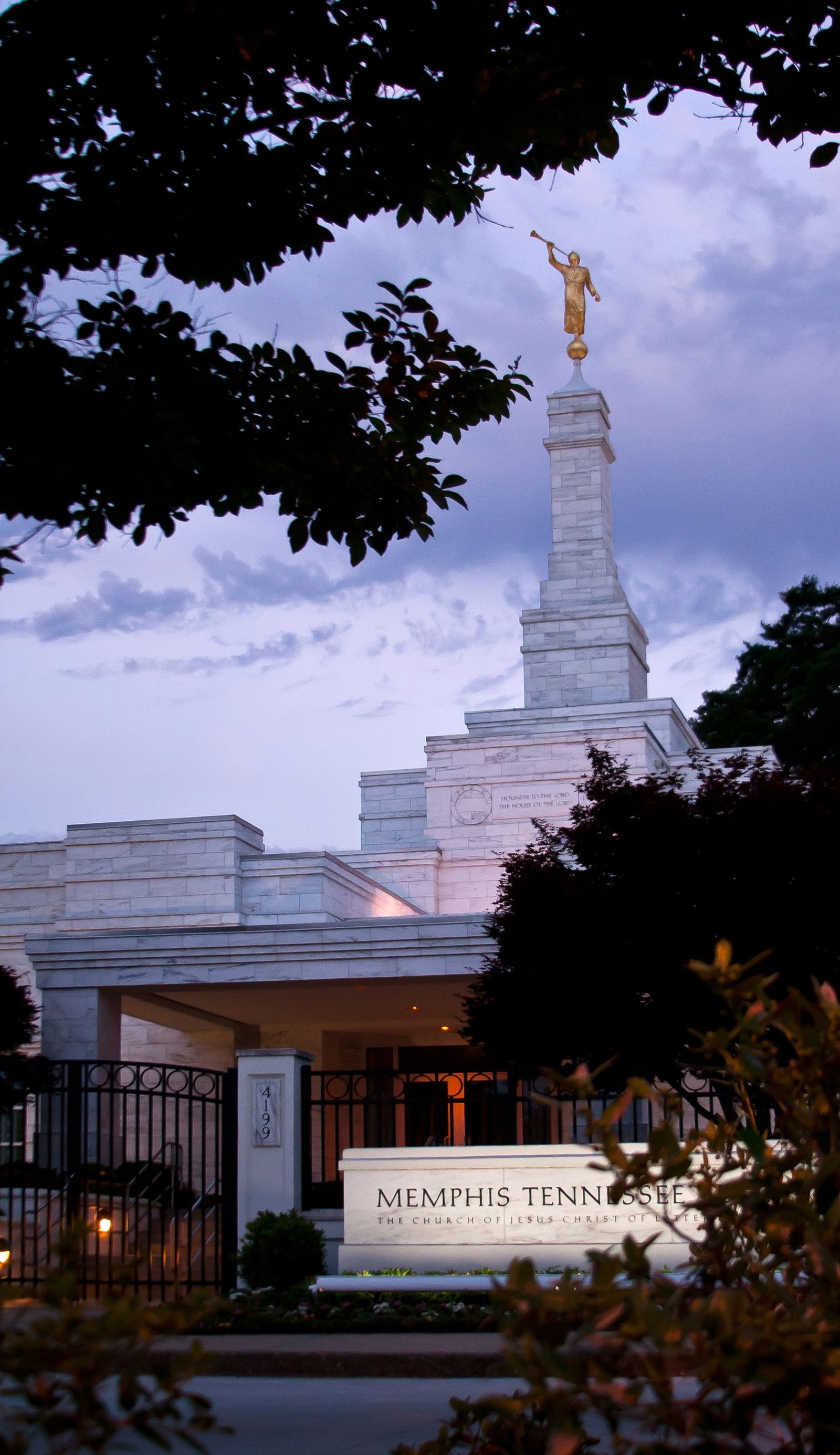 A portrait view of the Memphis Tennessee Temple with its sign in the front.