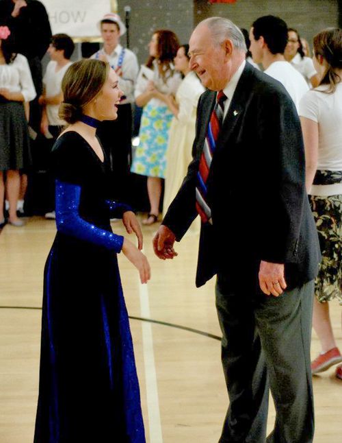 young woman and old man dancing