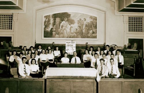 young adults gathered in a chapel for an activity