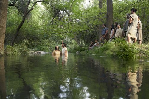 Alma the Younger baptizes Zeezrom as Amulek and others witness.