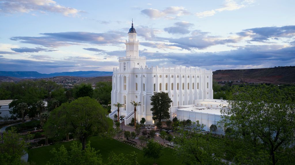 Exterior image of the St. George Utah Temple. The image features the temple set around trees surrounding the temple grounds. 