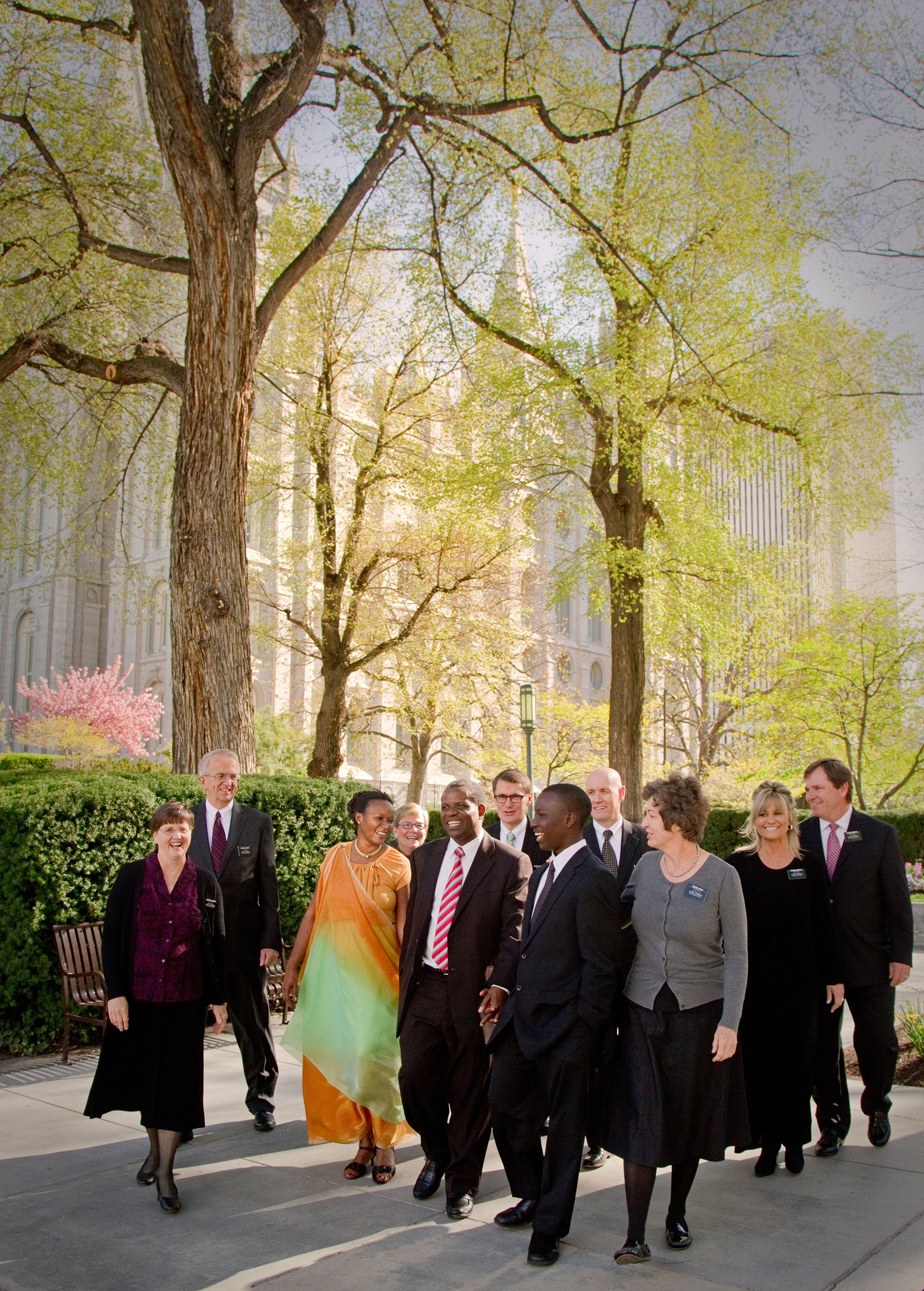 A group of senior missionary couples with a family on Temple Square.