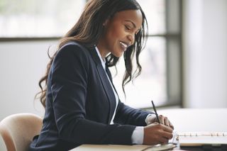 Women writing at desk