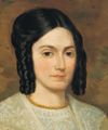 Portrait of Emma Smith with brown eyes and dark brown hair smoothed back from center part into three ringlets on either side. Small gold colored bead choker, buff shawl with lace collar.  Painted from an earlier version in 1843