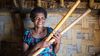 Woman in Vanuatu holding garden tools