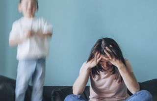 stressed mother having problem with noisy son