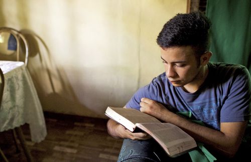 young man reading the scriptures