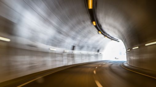 A blurry view of a road tunnel.