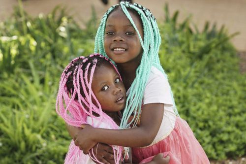 two girls with colored braids