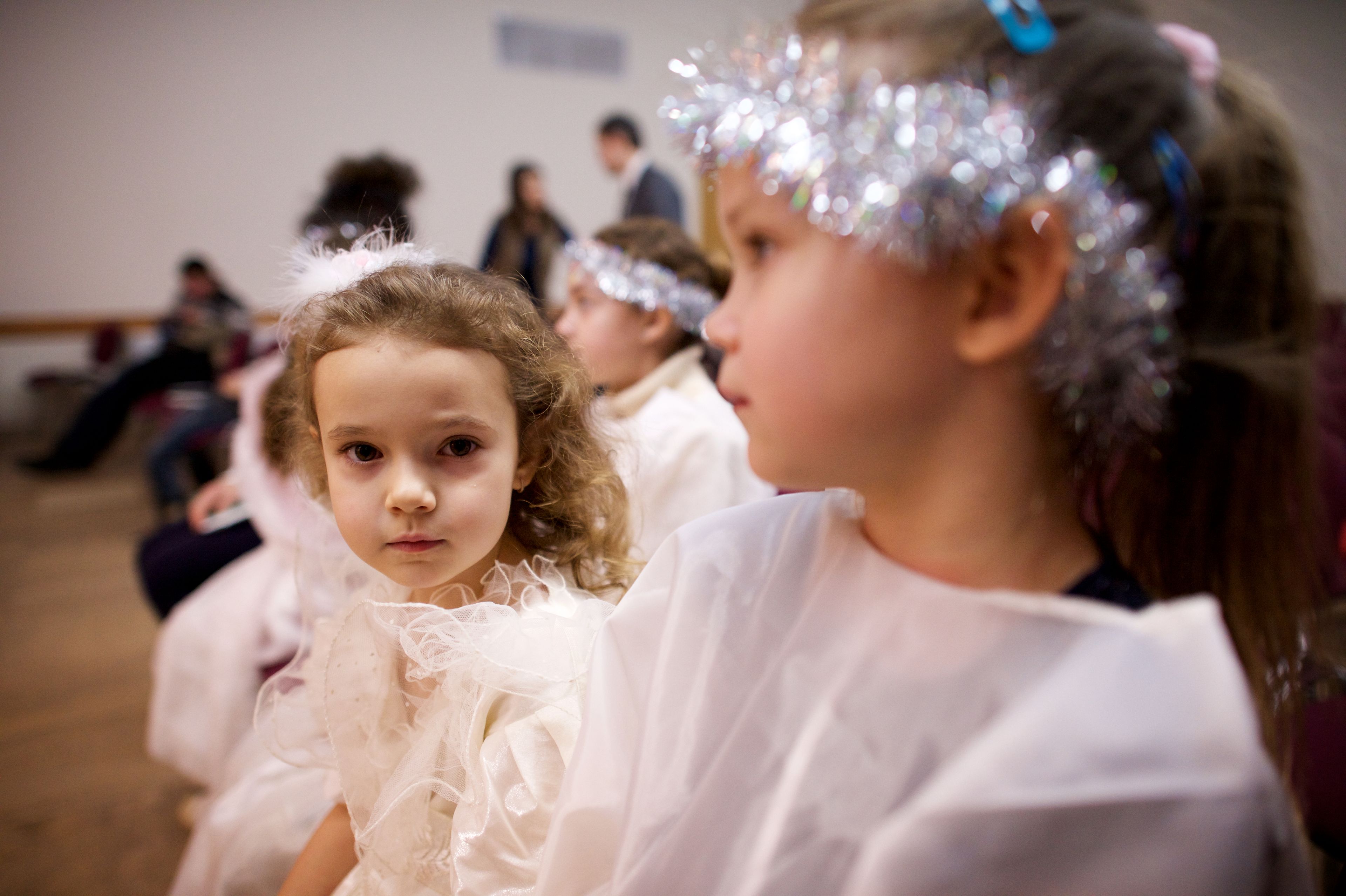 A number of images of children dressed up in costumes as they perform in a Christmas play at the Church Christmas Party.
