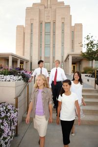 Young men and women walking away from the Oquirrh Mountain Utah Temple.