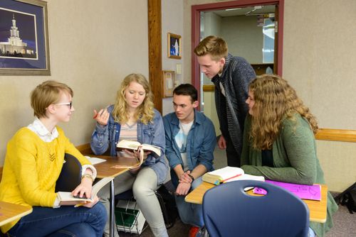 young women and men studying