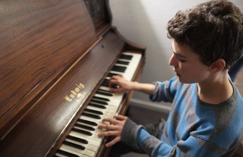 young man playing piano