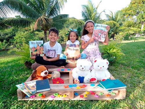 family reading the Friend magazine outside