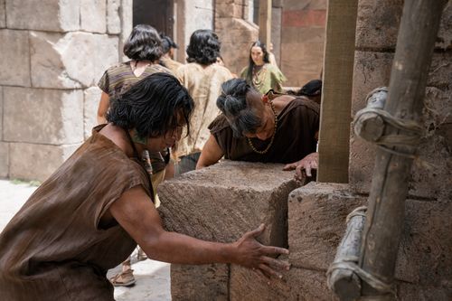 The people of Zeniff use various tools to repair the walls in the Land of Nephi.