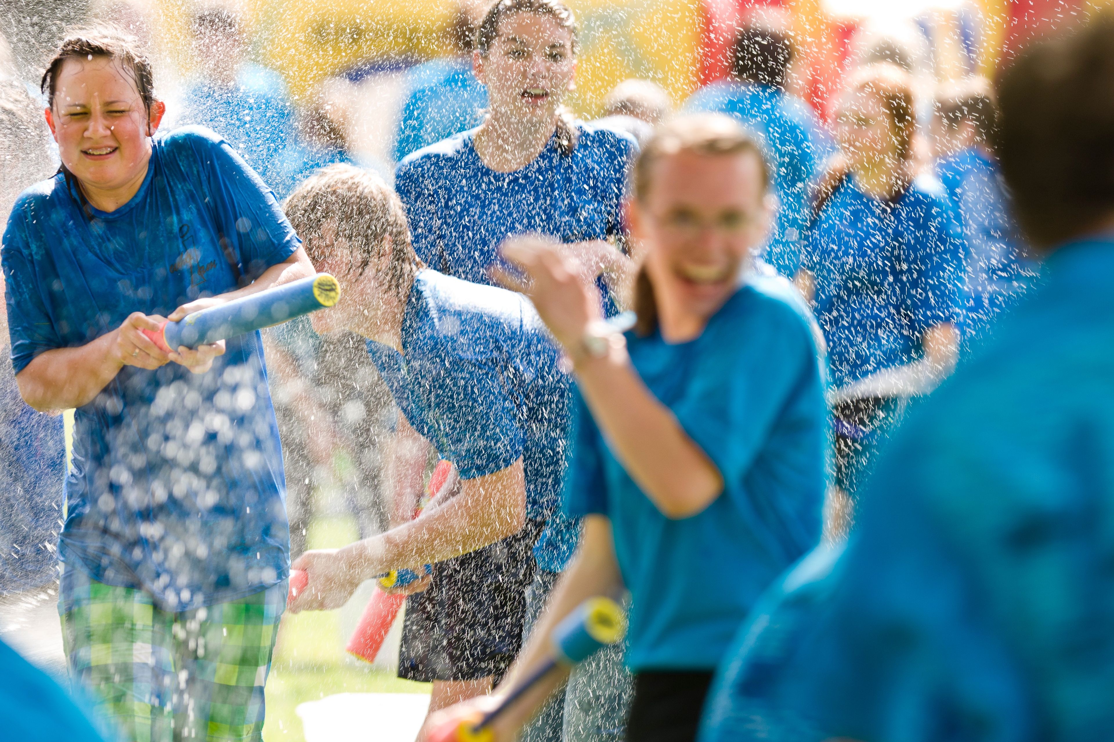 Youth having a water fight during a Youth Conference.
